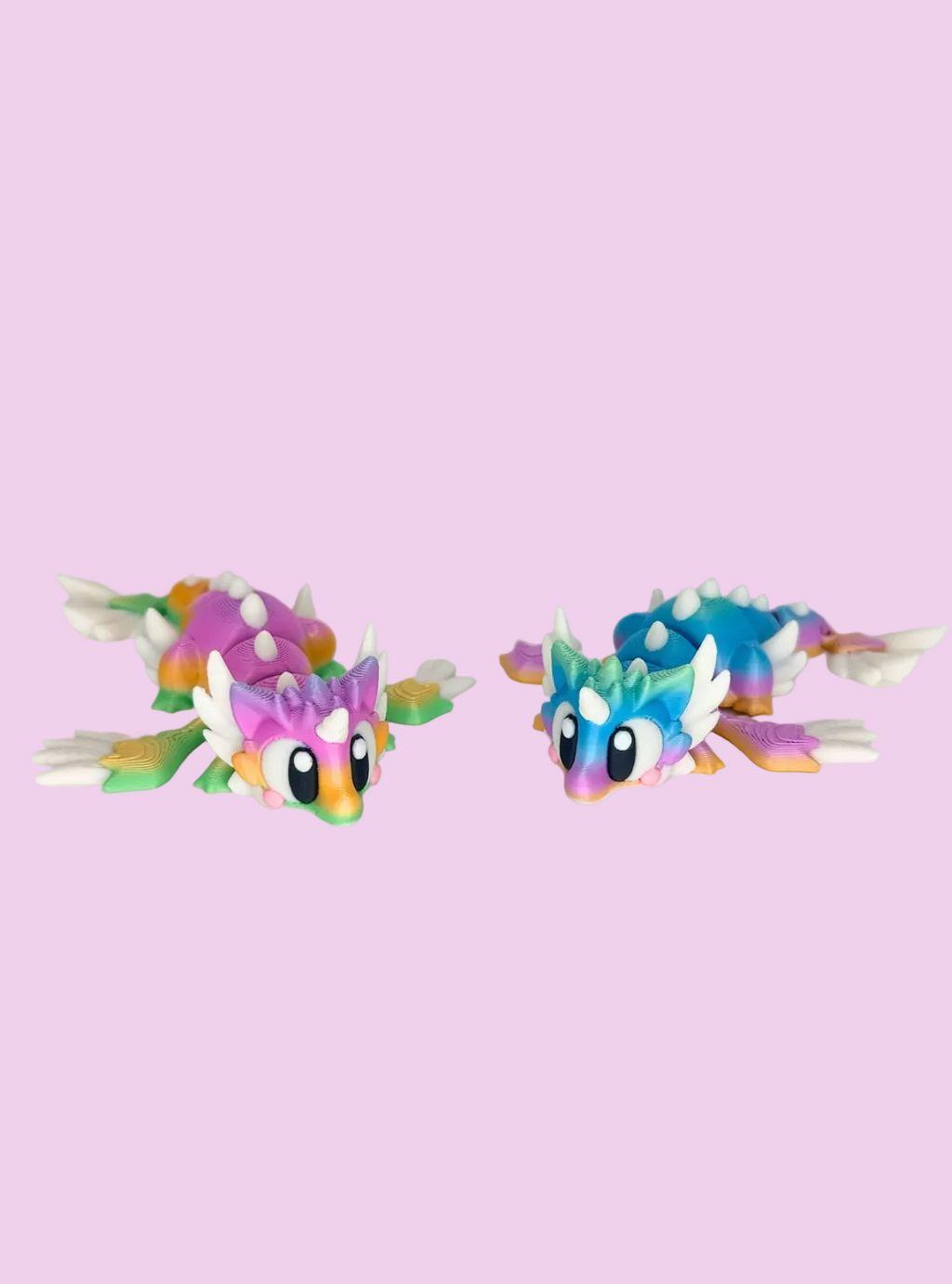 Two colorful dragon-shaped toys on a light gray background